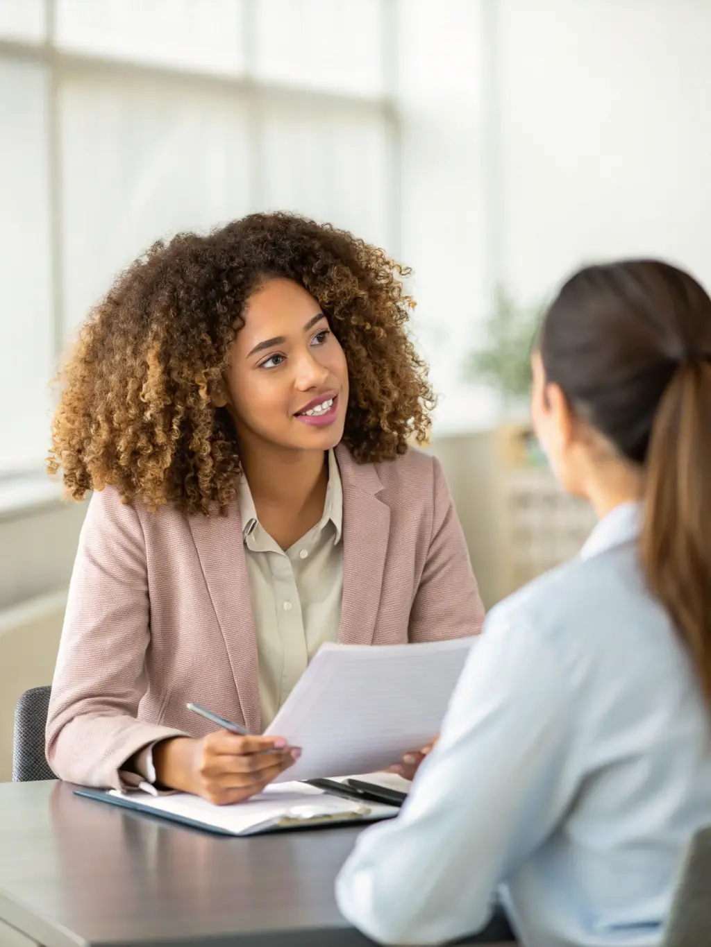 A person confidently participating in a mock interview session, receiving constructive feedback from an experienced social media professional, set in a modern office environment.