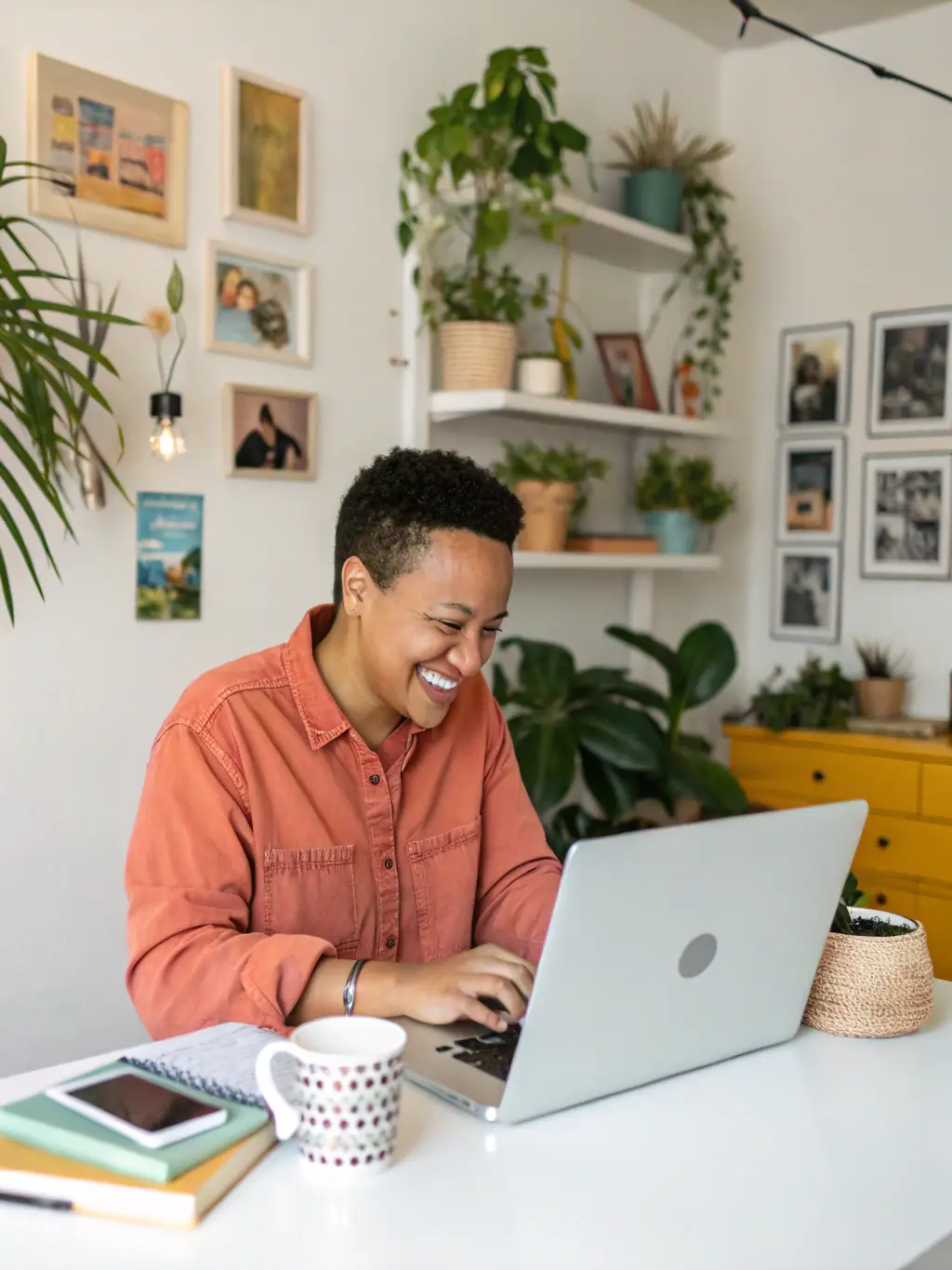 A professional workspace setup with a person happily working on a laptop, representing the flexibility and comfort of remote work offered through FlexJobs.