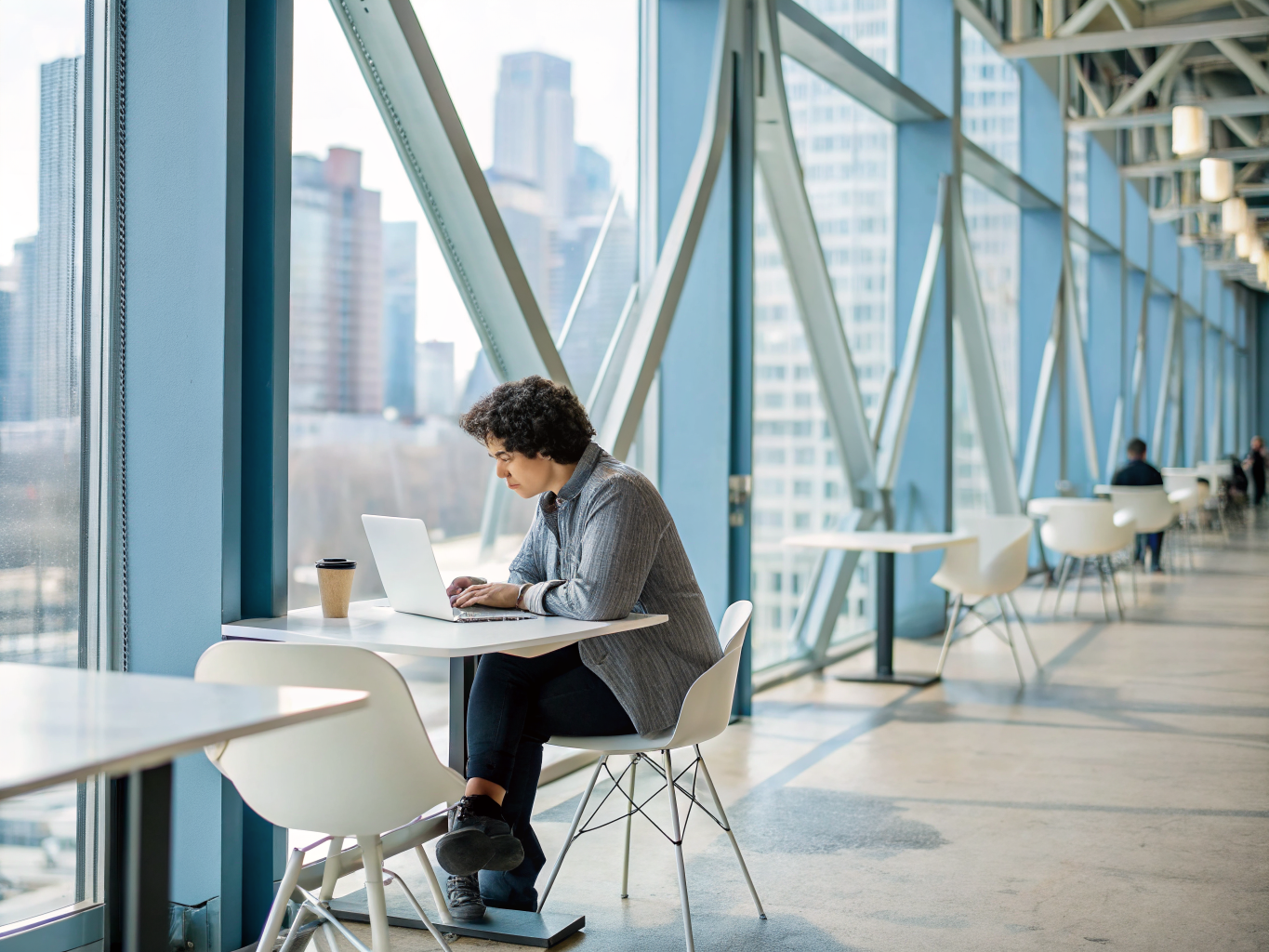 Freelancer reviewing hand-curated client opportunities on a laptop in a quiet coffee shop